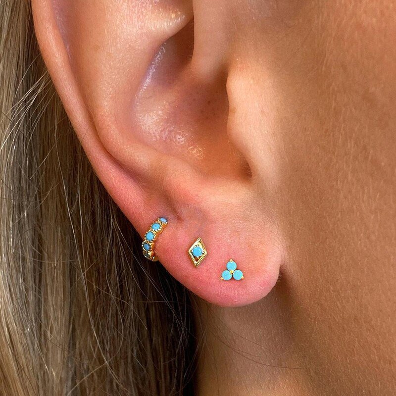 A model wearing the Turquoise Trinity Studs.