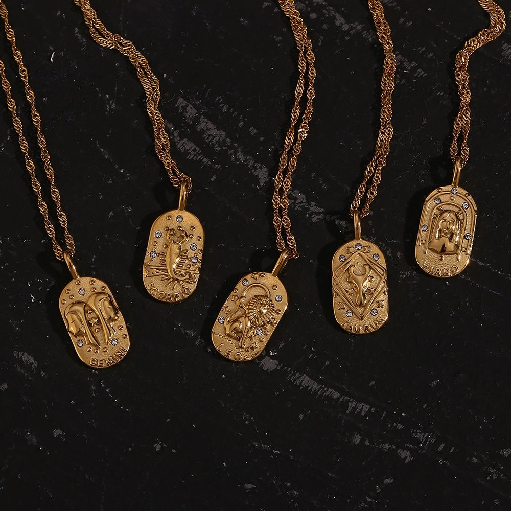 Closeup of multiple Zodiac Amulet Gold Necklaces.