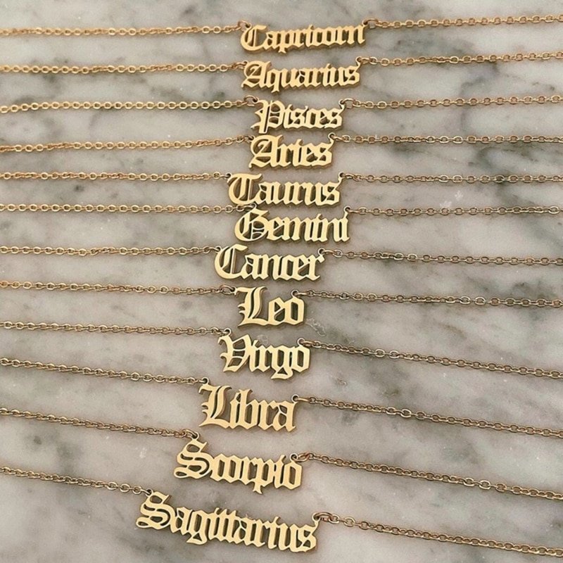 Tweleve old english zodiac name plate necklaces.