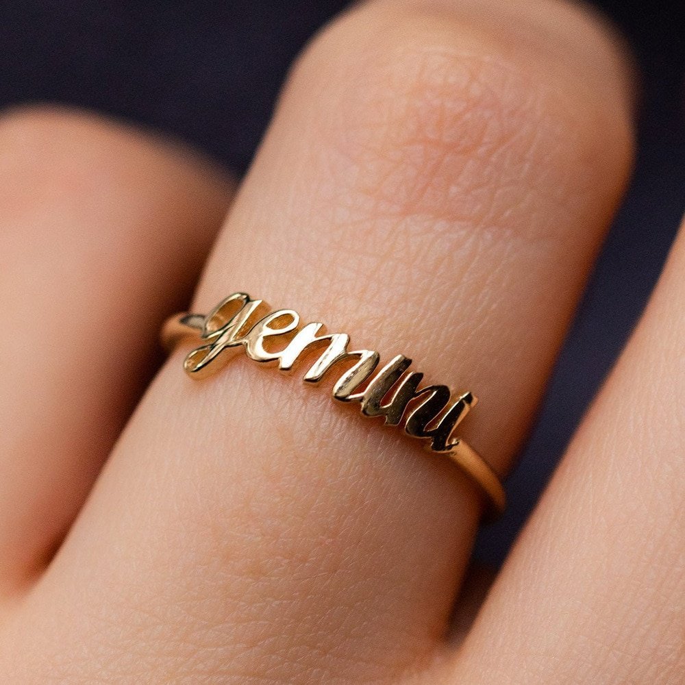 A model wearing a gold Gemini ring.