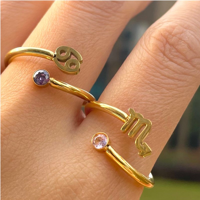 A model wearing two Zodiac Sign Birthstone Gold Rings.
